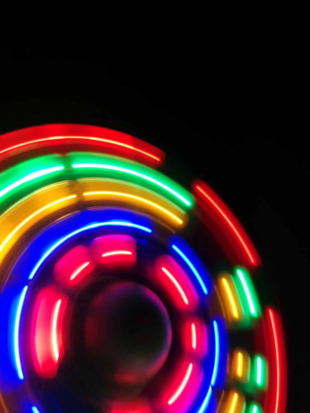 a close up of a neon colored object in the dark