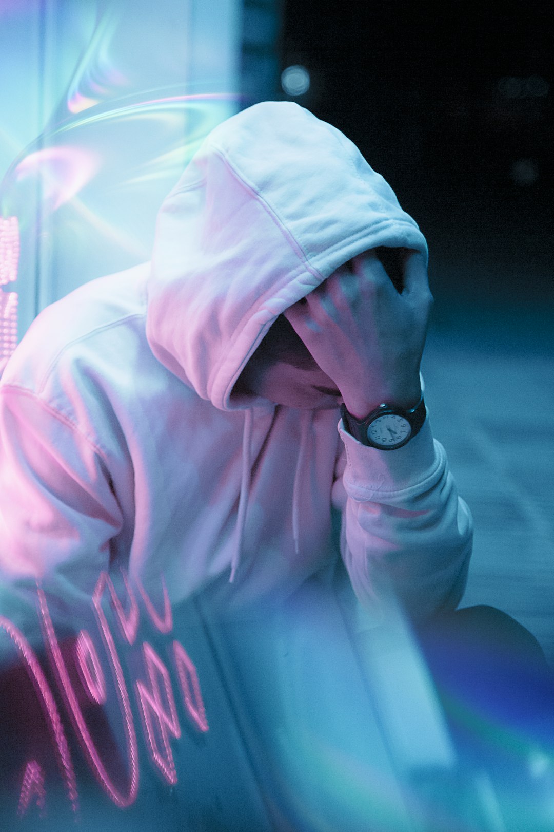 man in white hoodie wearing black round analog watch