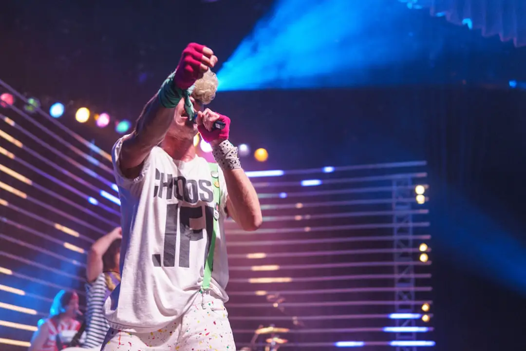 man holding microphone and bumpfist gesture