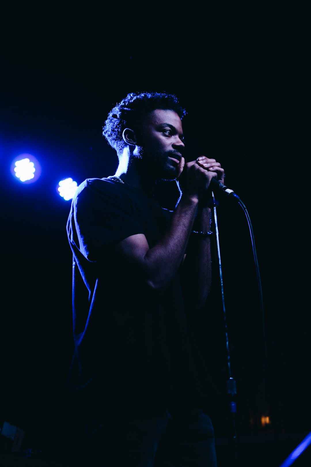 man standing while holding microphone