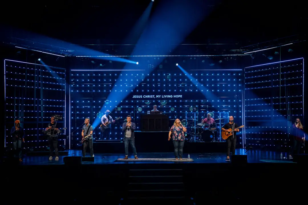 people standing on stage with blue lights