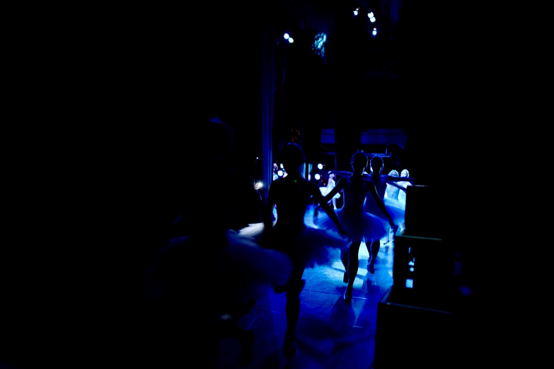 A group of people walking down a street at night
